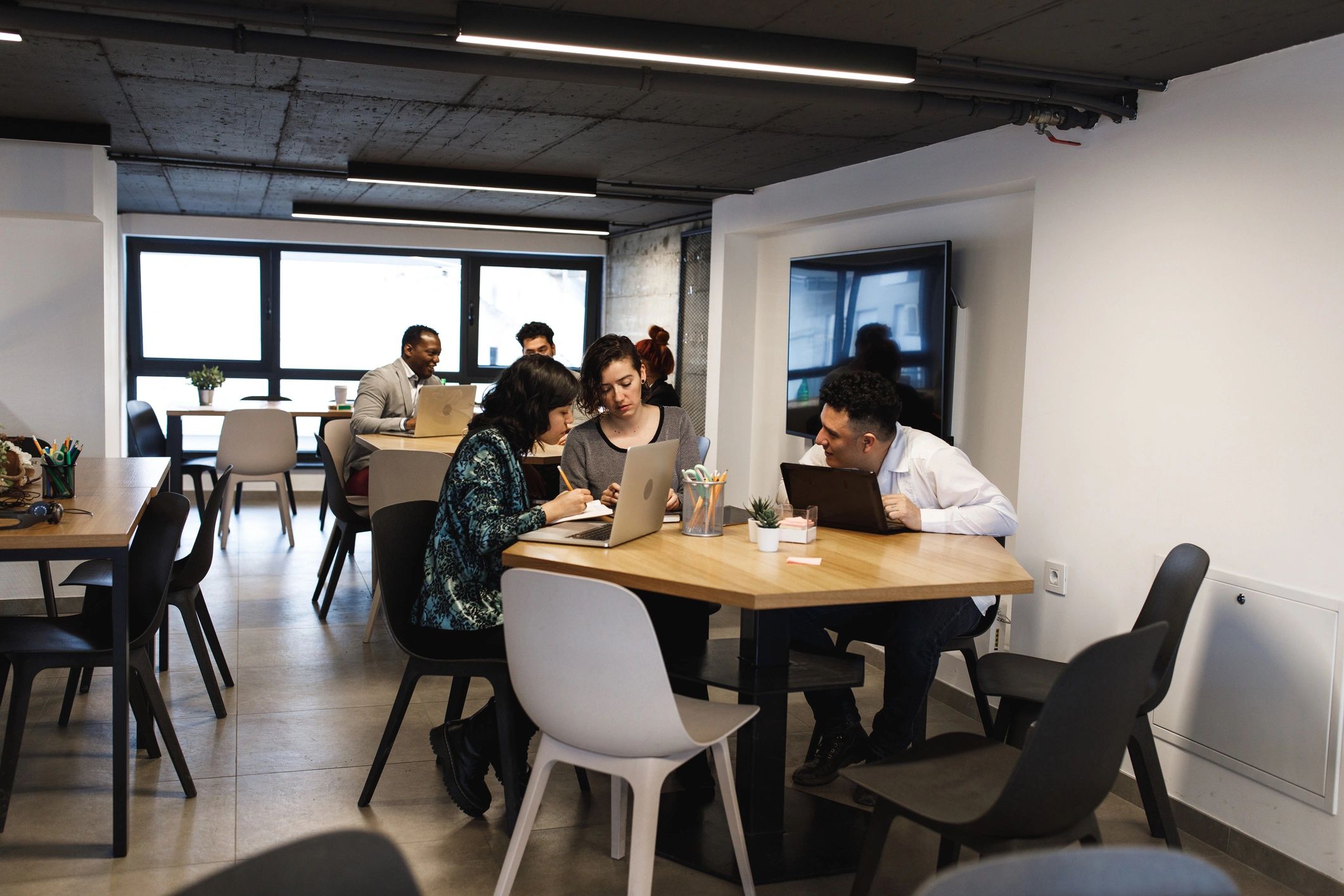 Community workspace where people collaborate at tables