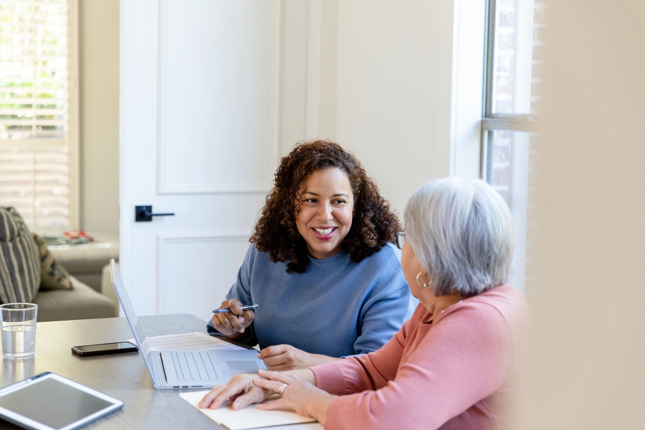 Volunteer helping a community member set up an online account