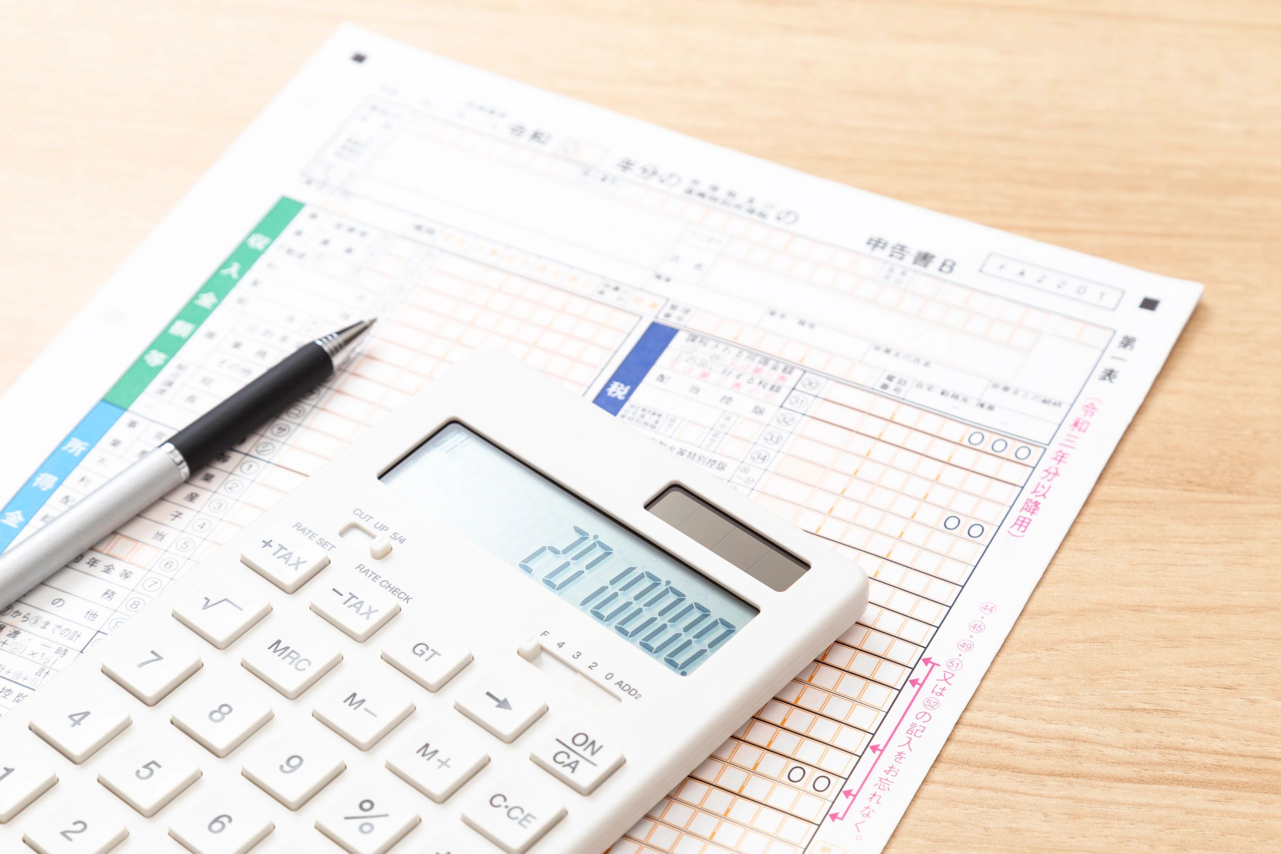 Tax documents and calculator on a desk