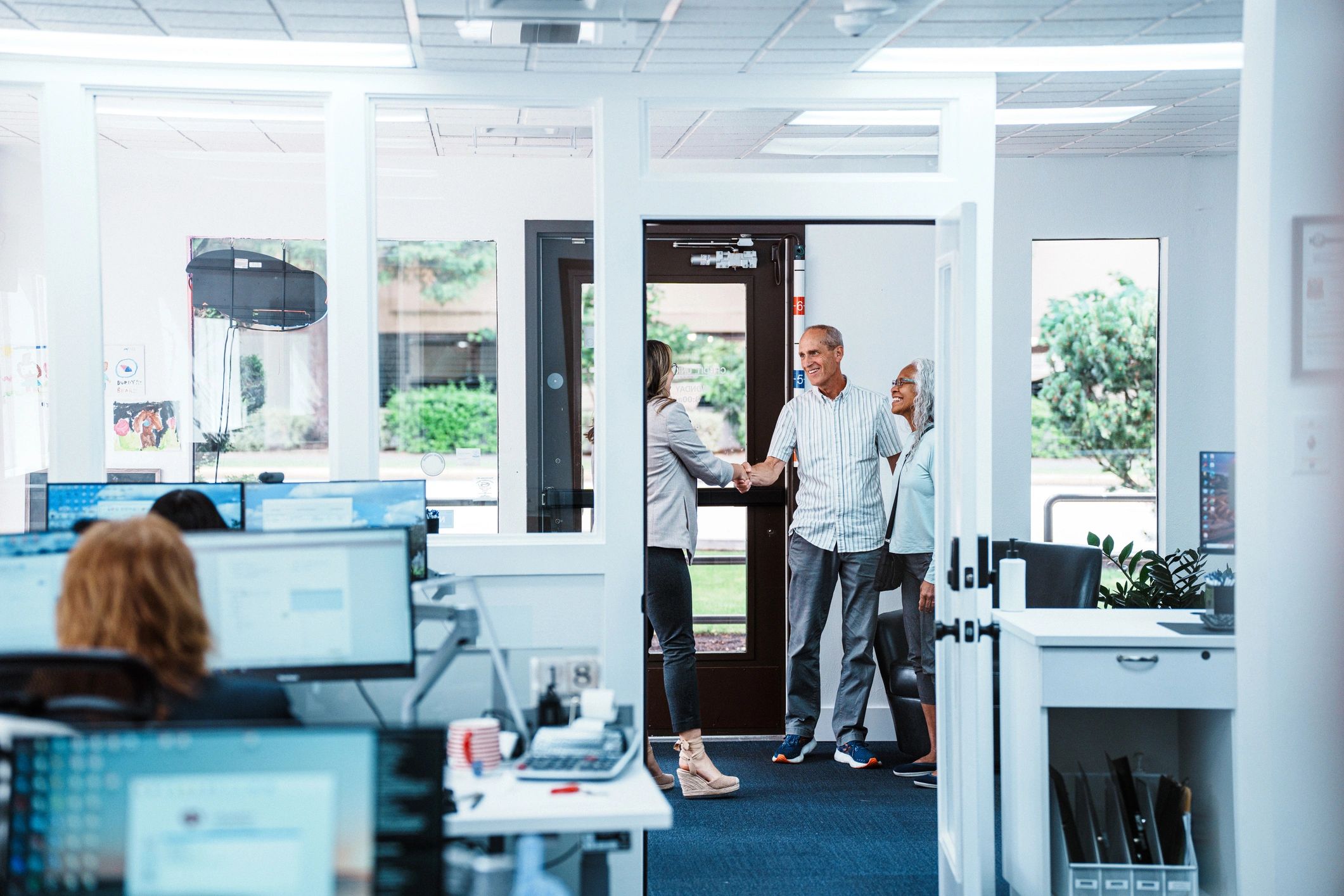Staff member greeting clients at a community office