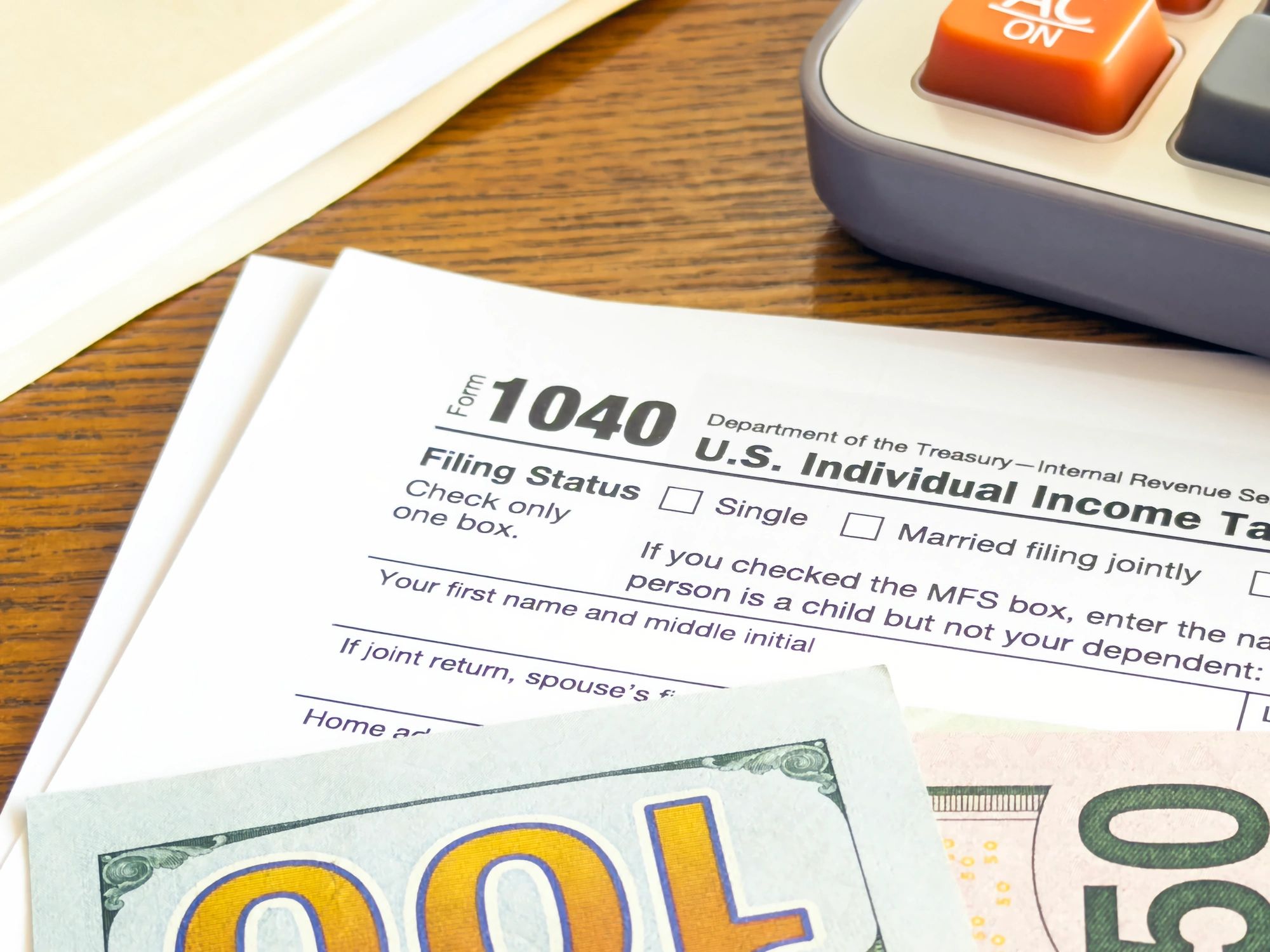 Tax form and calculator on a desk representing tax filing and preparation